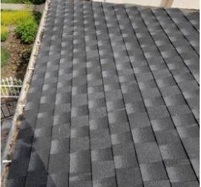 The same roof finished with new charcoal architectural asphalt shingles